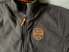 Giacca in pile nera STIHL con zip, dotata di logo arancione 