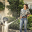 Vista laterale dell'idropulitrice Stihl RE 100 PLUS Control con avvolgitubo e accessori